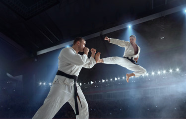 Karate fighters on tatami. Fighting Championship.