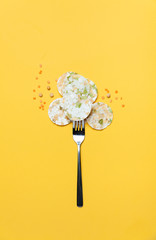 Vegeterian bean chips and lentils on yellow background. Top view.