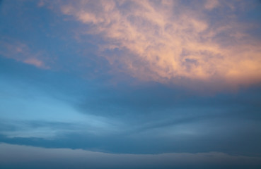 Red vivid clouds illuminated by the beam of the sun