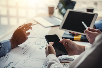 Team of website designers who are creative and planning to develop an application on the mobile phone in the office.