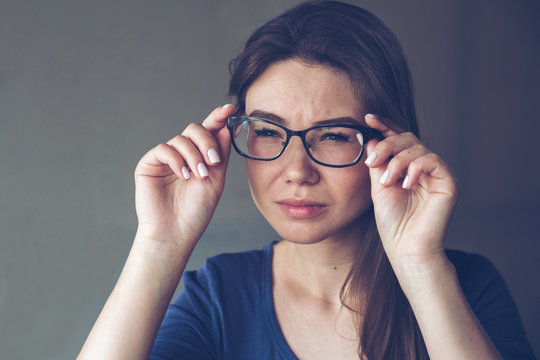 A Woman With Vision Problems Hold Eyeglasses