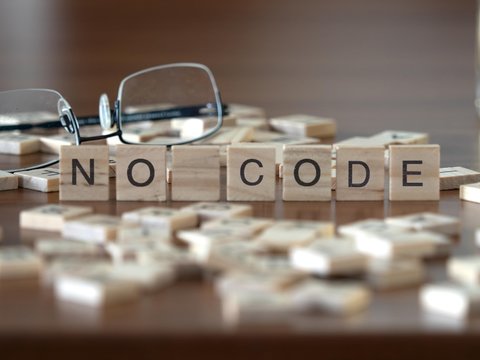 no code concept represented by wooden letter tiles