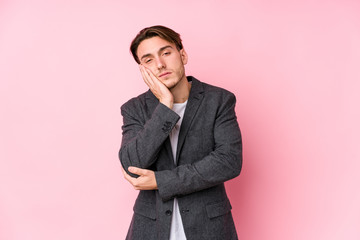 Young caucasian business man posing isolated who is bored, fatigued and need a relax day.