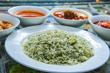 Chilli dip spicy on rice with different toppings.