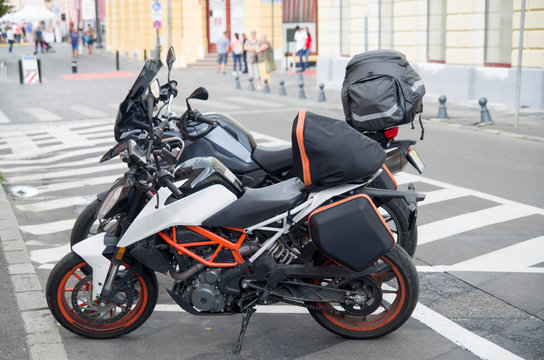 Two parked motorcycles with motor bags