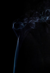 Abstract cloud of blue phantom color smoke swirling on black background