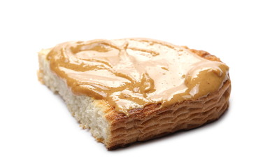 Peanut butter on toast slice, isolated on white background