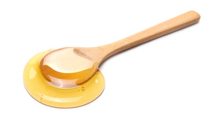 Honey with wooden spoon isolated on white background