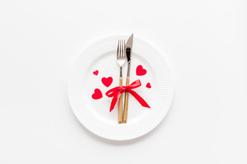 Valentines day table. Plate with decorative hearts on white background top-down copy space