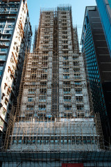 Bamboo scaffolding on building facade, bamboo pole framework