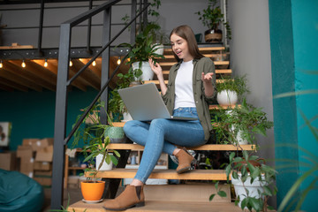 Young pretty woman having a video call with her friend