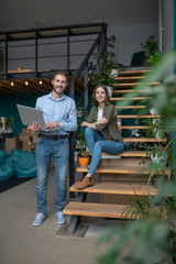 Man and a woman working out of office