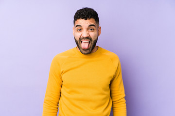 Young mixed race arabic man isolated funny and friendly sticking out tongue.