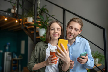 Woman showing a new app to her male friend