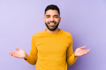 Young mixed race arabic man isolated showing a welcome expression.