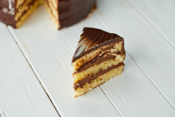 Dark chocolate vegan cake with candies and nuts on wooden background