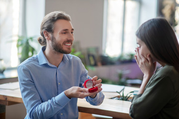 Smiling man making a proposal to the woman