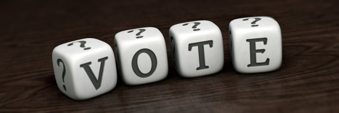 White cubes with word `VOTE` on wooden tabletop