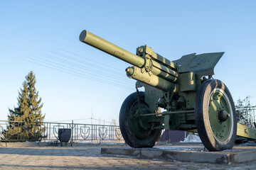 Anti tank gun in military park. Old anti tank cannon monument mounted on pedestal on winter day in...