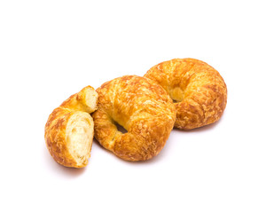 Two fresh baked French butter croissant with cutout piece isolated on white