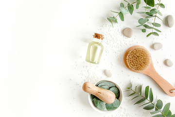 Spa concept with eucalyptus oil and eucalyptus leaf extract natural /organic spa cosmetics products, eco friendly bathroom accessories. Skincare concept on white background. Flat lay composition 