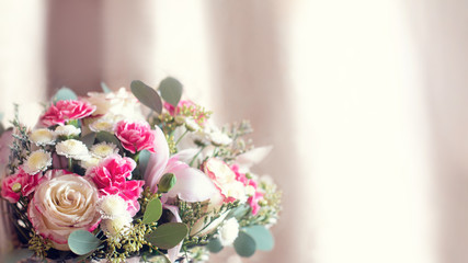 delicate flower arrangement. beautiful bouquet of pink flowers in basket on wooden table. wedding bouquet