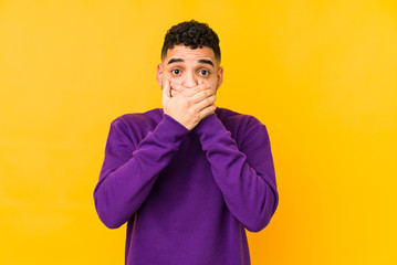 Young mixed race arabic man isolated shocked covering mouth with hands.