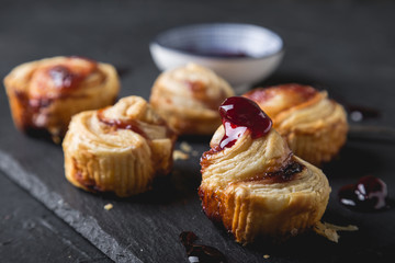 Small puff pastry rolls with cherry jam