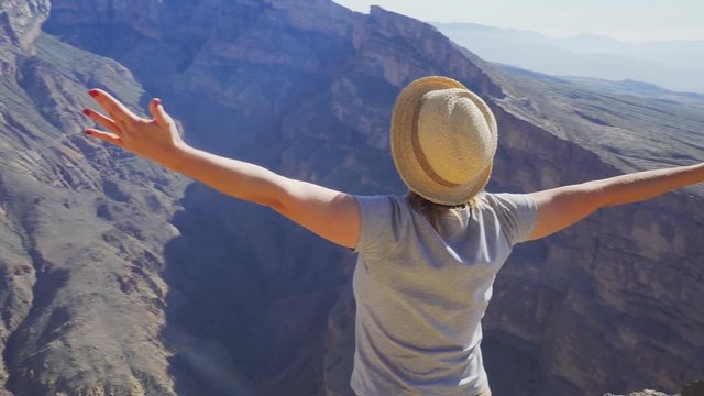Young Foreign Female Tourist Enjoying the View of Wadi Ghul aka Grand Canyon of Oman in Jebel Shams Mountains. Woman in Active Solo Travel in Middle East Countries