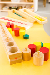 Selective focus of wooden games on yellow desk in school