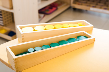 Selective focus of wooden educational games on yellow desk in class