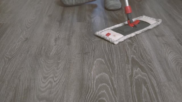 Mann wischt den Boden in der Wohnung