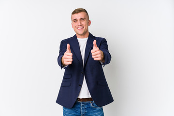Young business caucasian man with thumbs ups, cheers about something, support and respect concept.