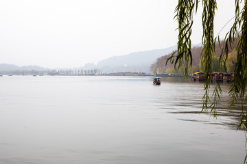grey winter lake with small boat
