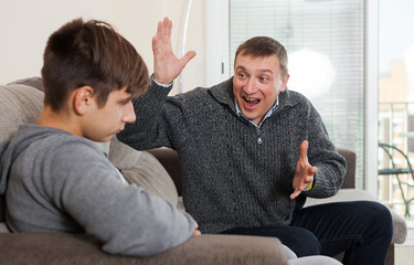 Dissatisfied father scolds young son