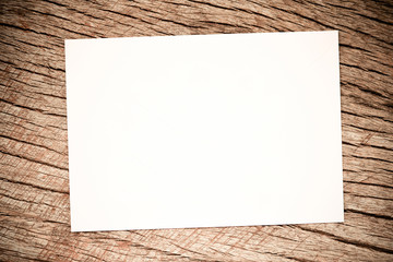 white paper on rustic wood background / Mock up photo paper on the table art tools white sheet a wooden table for text