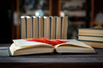 Obraz premium Open book with a bookmark on a wooden table.