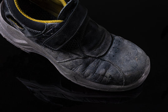 old working boots on black background