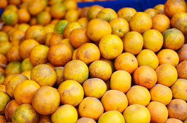 Pile of orange fruit for sale in the market - fresh orange background