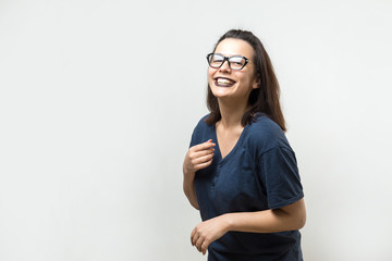Romantic  girl in trendy  glasses posing with shy smile. Studio close-up portrait on a white background.