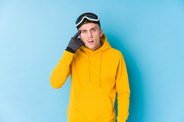 Young skier man showing a disappointment gesture with forefinger.