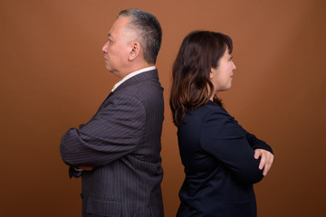 Mature Asian businessman and mature Asian businesswoman together