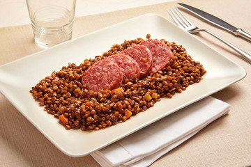 Cotechino and lentils served on a platter