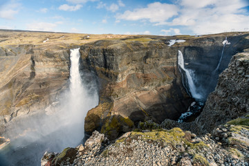 Haifoss and Granni waterfalls in the Icelandic highlands during nice warm weather. Blue cloudy sky...