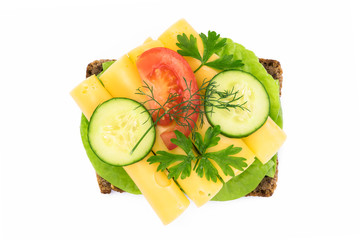 Top view of a healthy sandwich with dark full grain rye bread, vegetables and cheese isolated on a white background without shadows