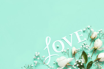 Flowers and LOVE lettering on a light green background