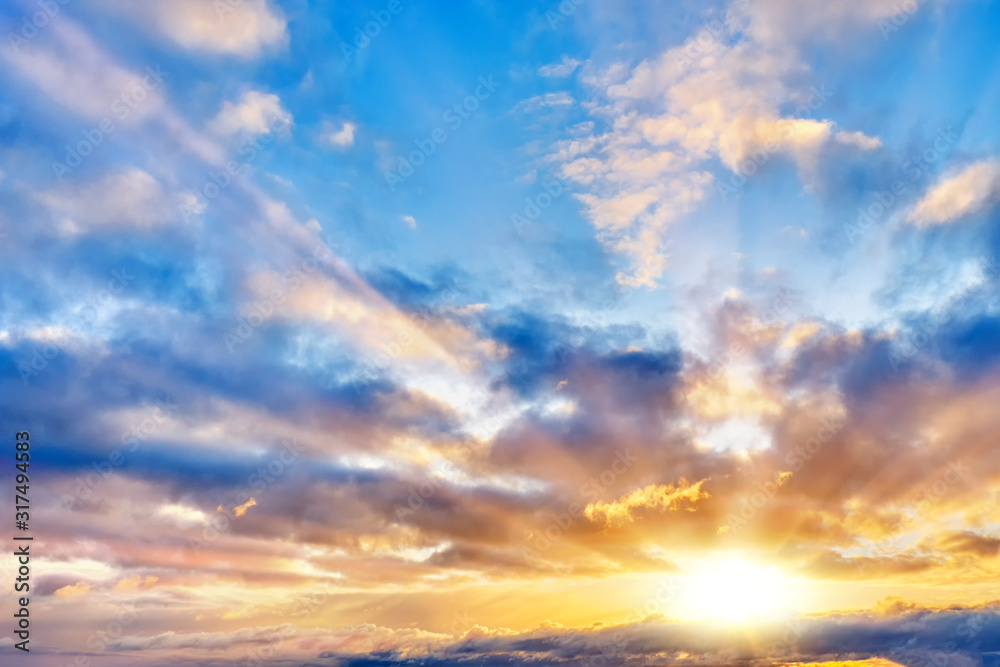 Wall mural sunset sky landscape background natural color of evening cloudscape with setting sun light coming th