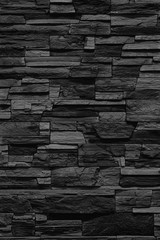 Fasing stone wall of natural stones. Rustic stone wall covering with natural stones.