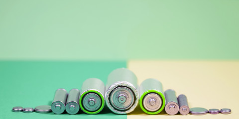 Many different types used or new battery, rechargeable accumulator, alkaline batteries on color...