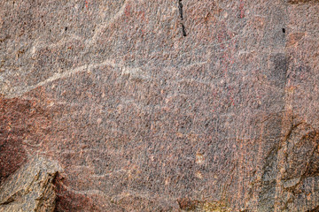 Stone background, rock wall backdrop with rough texture. Abstract, grungy and textured surface of stone material. Nature detail of rocks.